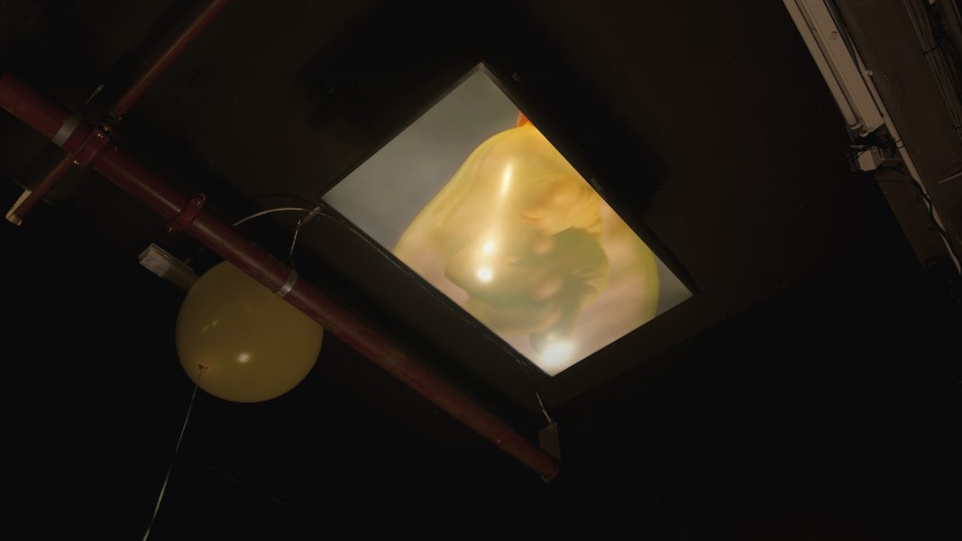 Otu of Her e, 2021, 3’02’’, 3 channel moving image & balloon installation, looped video installed on the sealing